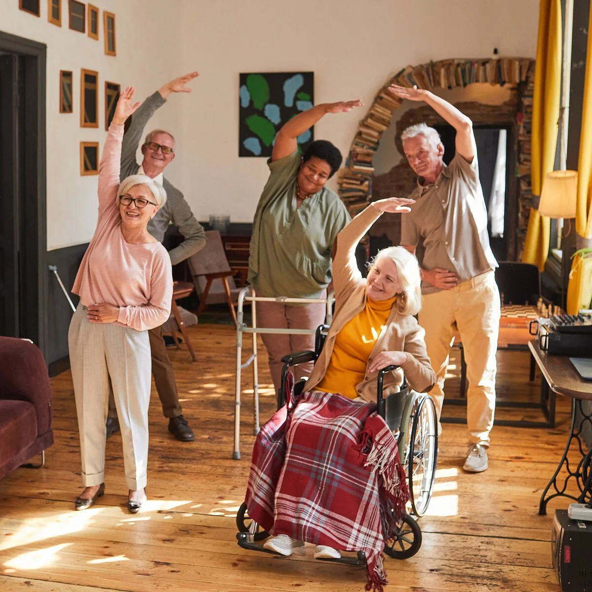 Senior People Stretching in Retirement Home Portrait young woman coordinating group of senior people enjoying morning exercises in retirement home, copy space